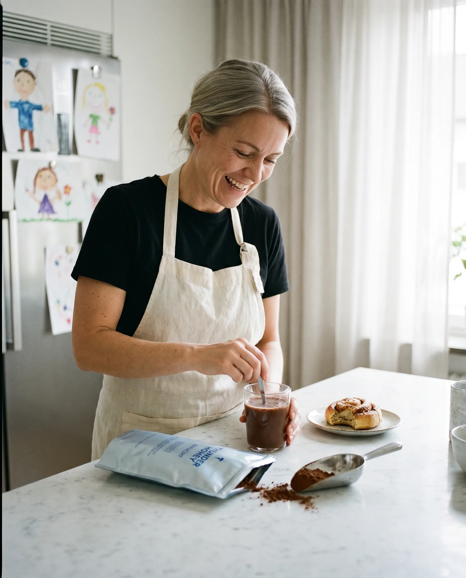 A Swedish mother in her 40s with a warm mug in a busy home, the everyday Thunder Honey Daylight drinker who swapped coffee for cacao