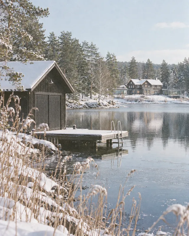The dock and boathouse in fresh snow, the club across the water