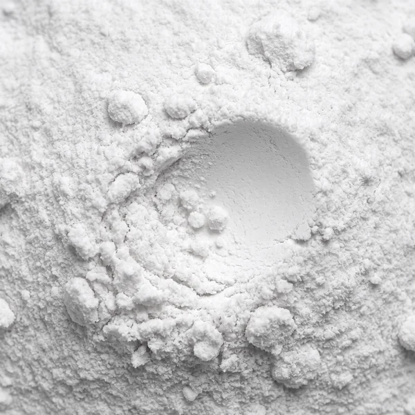 CDP-Choline up close, a soft matte ivory powder with a small hollow pressed into it