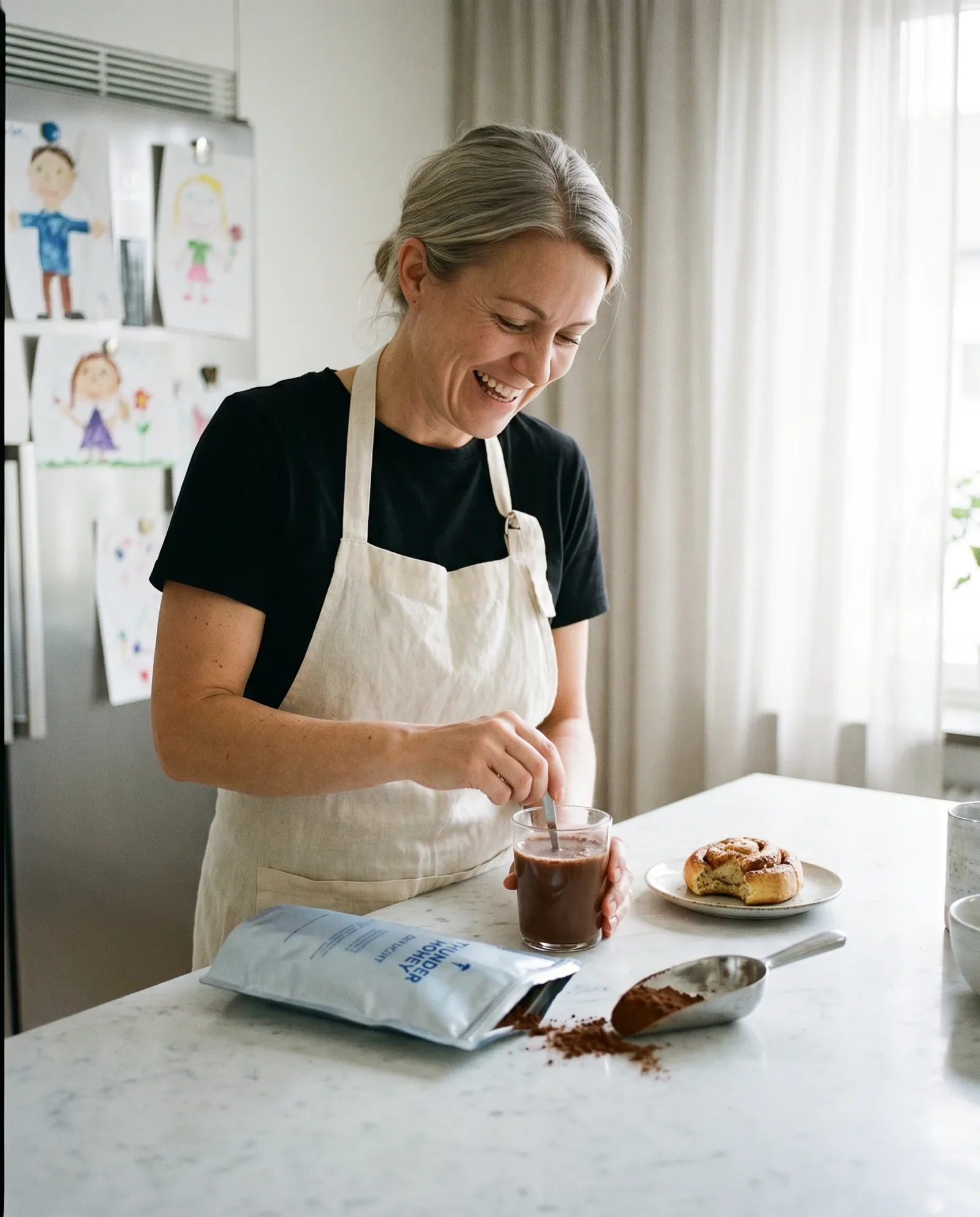 A Swedish mother in her 40s with a warm mug in a busy home, the everyday Thunder Honey Daylight drinker who swapped coffee for cacao