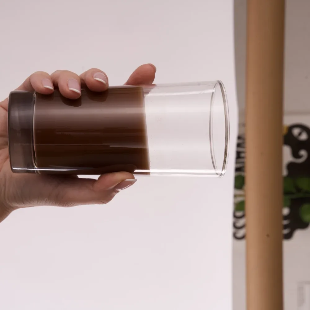 A glass of Thunder Honey cacao held in hand