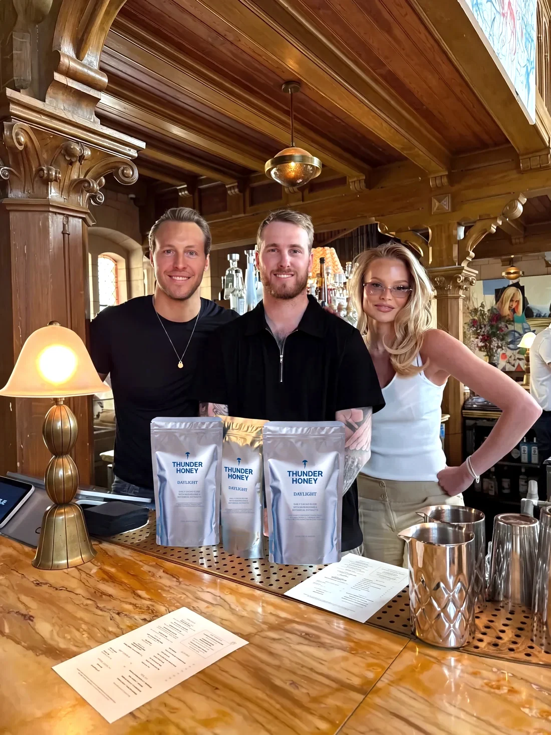 Thunder Honey founders behind a retail counter with the product range